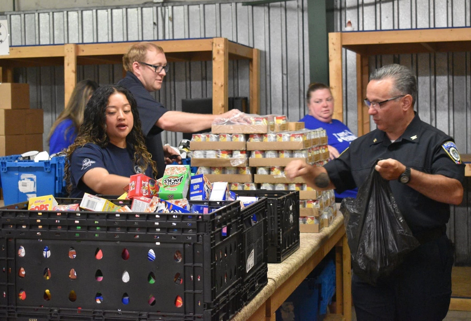 Volunteers packing food boxes at a food bank